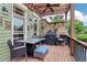 Outdoor deck features a dining table, grill, stone wall, and ceiling fan for the perfect outdoor entertainment space at 4588 Pine Se St, Smyrna, GA 30080