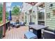 Relaxing outdoor deck features a dining table, comfortable seating, and a stone accent wall for enjoying the outdoors at 4588 Pine Se St, Smyrna, GA 30080