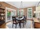 Stylish dining room featuring exposed brick walls, hardwood floors, and a modern chandelier at 4588 Pine Se St, Smyrna, GA 30080