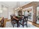 Elegant dining room featuring exposed brick walls, a large table, and access to an outdoor deck at 4588 Pine Se St, Smyrna, GA 30080