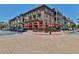 A charming, multi-story building with brick facade, multiple balconies, and outdoor seating at 4588 Pine Se St, Smyrna, GA 30080