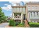 Charming two-story home featuring a quaint porch with a garden and a brick-lined walkway up to the front door at 4588 Pine Se St, Smyrna, GA 30080