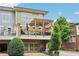 Charming townhome features a covered deck with pergola, and a well-maintained lawn adding to its curb appeal at 4588 Pine Se St, Smyrna, GA 30080