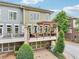 Beautiful townhome boasts a covered deck with stone accents, offering an inviting outdoor space above the garage at 4588 Pine Se St, Smyrna, GA 30080