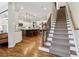 Inviting foyer featuring gleaming hardwood floors, elegant staircase, and views to the kitchen at 4588 Pine Se St, Smyrna, GA 30080