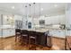 Well-lit kitchen with granite countertops, pendant lighting, stainless appliances, and a large island at 4588 Pine Se St, Smyrna, GA 30080