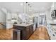 Open-concept kitchen featuring a large island with seating, stainless steel appliances, and white cabinetry at 4588 Pine Se St, Smyrna, GA 30080