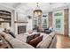 Elegant living room with a fireplace, built-in shelves, exposed brick wall, and coffered ceilings at 4588 Pine Se St, Smyrna, GA 30080