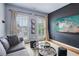 Cozy living room featuring a plush gray sofa, modern coffee table, and beach-themed wall art at 4588 Pine Se St, Smyrna, GA 30080