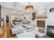 Bright open-concept living room open to the kitchen, a fireplace, and neutral decor at 4588 Pine Se St, Smyrna, GA 30080