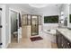 Elegant main bathroom with tiled shower, soaking tub, and decorative moss art at 4588 Pine Se St, Smyrna, GA 30080