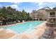 Community pool with ample seating and lounge chairs, surrounded by mature trees for a relaxing atmosphere at 4588 Pine Se St, Smyrna, GA 30080