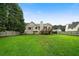 Spacious backyard featuring a well-maintained lawn, wooden fence and deck on the rear of the home at 74 Knights Ct, Dallas, GA 30157