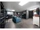 Finished basement area with dark laminate flooring, a seating area, and built-in bookshelves at 74 Knights Ct, Dallas, GA 30157