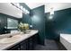 Bathroom featuring double sinks and a nearby soaking tub, perfect for unwinding after a long day at 74 Knights Ct, Dallas, GA 30157