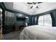 Main bedroom boasts a tray ceiling, dark accent walls, and a TV, creating a relaxing and private retreat at 74 Knights Ct, Dallas, GA 30157