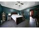 Spacious bedroom featuring a tray ceiling, dark accent walls, and a connecting door to the adjacent room at 74 Knights Ct, Dallas, GA 30157