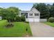 Well-maintained home with a lush green lawn and mature trees at 74 Knights Ct, Dallas, GA 30157