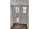 Bright living room with wood floors, high ceilings, a ceiling fan, and two large windows at 80 Heyman Dr, Covington, GA 30016