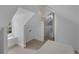 Attic space featuring bright white walls and carpeting with a small window at 2596 Midway Rd, Decatur, GA 30030