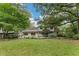 Expansive lawn with mature trees partially obscuring view of house at 2596 Midway Rd, Decatur, GA 30030