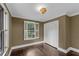 Bedroom with dark wood floors, white trim, and a large window with shutters at 2596 Midway Rd, Decatur, GA 30030
