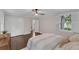 Bright bedroom features hardwood floors, ceiling fan, and natural light from the window at 2596 Midway Rd, Decatur, GA 30030