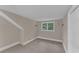 Bright bedroom featuring soft carpeting, a window, and fresh paint at 2596 Midway Rd, Decatur, GA 30030
