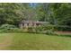 Well-manicured front lawn with beautiful landscaping and a charming home at 2596 Midway Rd, Decatur, GA 30030