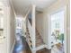 Hallway with view into kitchen and living room with staircase and dark wood floors at 2596 Midway Rd, Decatur, GA 30030