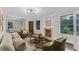 Bright living room features a cozy fireplace, a modern light fixture and a view to the dining area at 2596 Midway Rd, Decatur, GA 30030