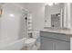 Full bathroom with a shower-tub combo, granite vanity, and neutral colors at 267 Snow Owl Way, Lawrenceville, GA 30044