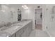 Bright bathroom with double sinks, granite countertops, walk-in shower, and large walk-in closet at 267 Snow Owl Way, Lawrenceville, GA 30044
