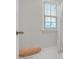 Clean bathroom featuring white tile and a window with blinds at 267 Snow Owl Way, Lawrenceville, GA 30044