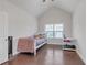 Cozy bedroom with a sloped ceiling, a twin bed, and hardwood floors at 267 Snow Owl Way, Lawrenceville, GA 30044