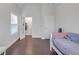 Bright bedroom boasts wood floors, a door to a walk-in closet, and a window at 267 Snow Owl Way, Lawrenceville, GA 30044