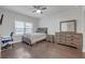 Bedroom with hardwood floors, a large window, ceiling fan, and desk at 267 Snow Owl Way, Lawrenceville, GA 30044