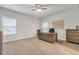 Bedroom with plush carpet, a large window, a desk, and wooden furnishings at 267 Snow Owl Way, Lawrenceville, GA 30044