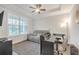 Cozy bedroom with tray ceilings, large window, and comfortable furnishings, perfect for relaxation at 267 Snow Owl Way, Lawrenceville, GA 30044