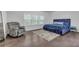 Spacious bedroom with hardwood floors, chair, large windows, and stylish decor at 267 Snow Owl Way, Lawrenceville, GA 30044
