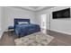 Beautiful bedroom with hardwood floors, modern decor, a stylish bed, and lots of natural light at 267 Snow Owl Way, Lawrenceville, GA 30044
