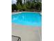 Community pool surrounded by lounge chairs and lush green landscaping at 267 Snow Owl Way, Lawrenceville, GA 30044