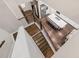 Open-concept kitchen with a large island, white cabinetry, stainless steel appliances, and hardwood floors at 267 Snow Owl Way, Lawrenceville, GA 30044