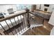 Stairway view into living room with a fireplace, open floor plan, and hardwood floors at 267 Snow Owl Way, Lawrenceville, GA 30044