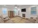 Comfortable living room featuring a fireplace, hardwood floors, ample seating and lots of natural light at 267 Snow Owl Way, Lawrenceville, GA 30044