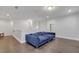 Comfortable upstairs living room with hardwood floors, recessed lighting, and modern blue sofa at 267 Snow Owl Way, Lawrenceville, GA 30044