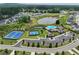 This aerial view showcases the community's amenities, including tennis courts, swimming pool, lake, and well-maintained landscaping at 3525 Montebello Pkwy, Cumming, GA 30028
