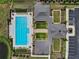 Aerial view of a community pool and clubhouse with meticulously landscaped grounds and ample parking at 3525 Montebello Pkwy, Cumming, GA 30028