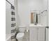 Compact bathroom features a toilet, and vanity cabinet with a shower-tub combination at 3525 Montebello Pkwy, Cumming, GA 30028