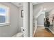 Bathroom with a toilet next to a window and a walk-in closet with wooden floors and wire shelving at 3525 Montebello Pkwy, Cumming, GA 30028